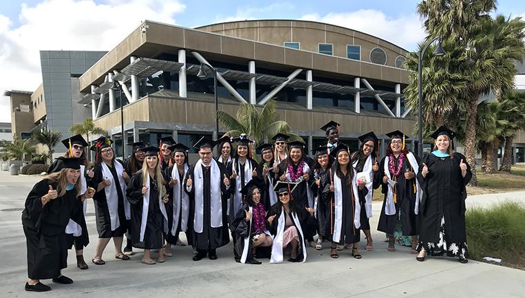 Photo of the front of LRC with graduates from the program 20