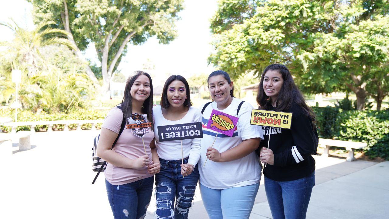 Group of students pose with college signs at FYE Expo